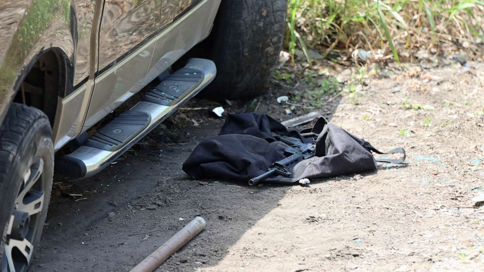 PHOTO: A gun lies on the ground next to the vehicle the suspect crashed near Robb Elementary School, May 24, 2022, in Uvalde, Texas.