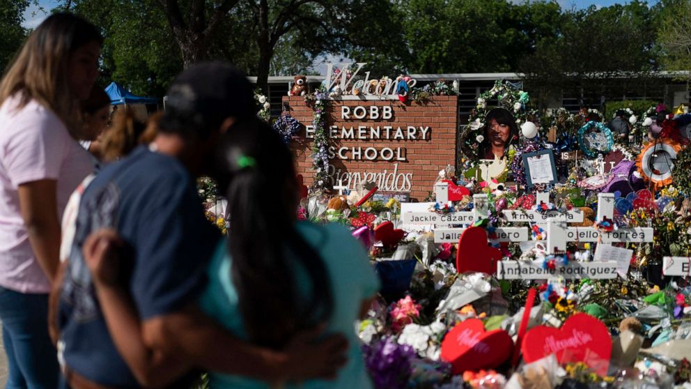 PHOTO: People visit a memorial at Robb Elementary School in Uvalde, Texas, on June 2, 2022, to pay their respects to the victims killed in a school shooting.