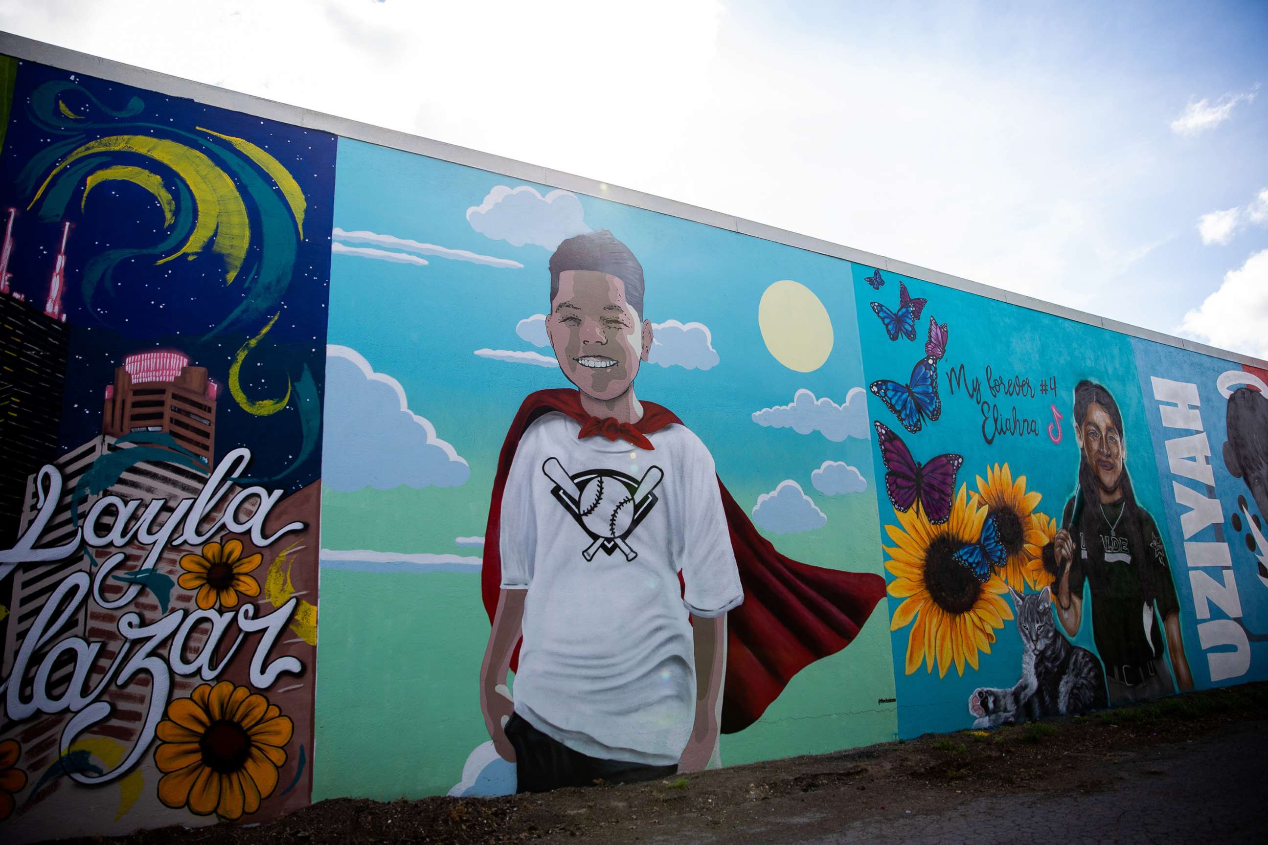 PHOTO: A mural in honor of Jose Manuel Flores Jr. (wearing the cape), along with other children lost in the Robb Elementary school shooting, decorate the wall of a building in downtown Uvalde, Texas, Aug. 21, 2022.