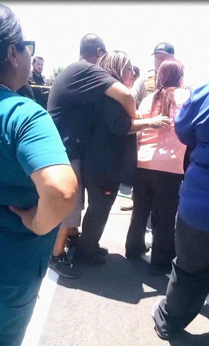 PHOTO: Distressed people stand near law enforcement officers outside Robb Elementary School in Uvalde, Texas, on May 24, 2022, in an image taken from video.