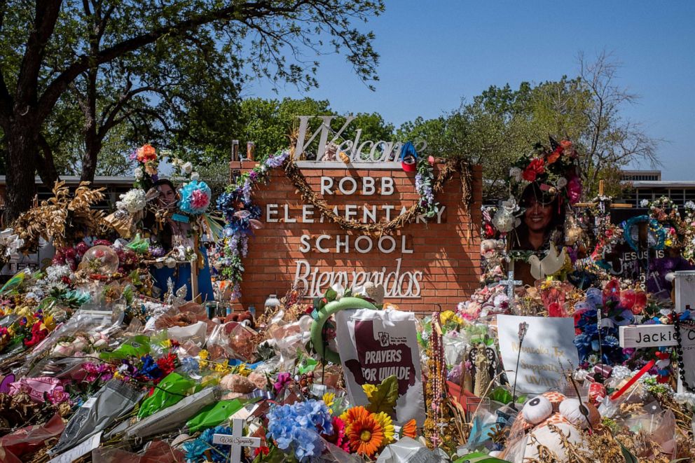 PHOTO: The Robb Elementary School sign is seen covered in flowers and gifts on June 17, 2022, in Uvalde, Texas.