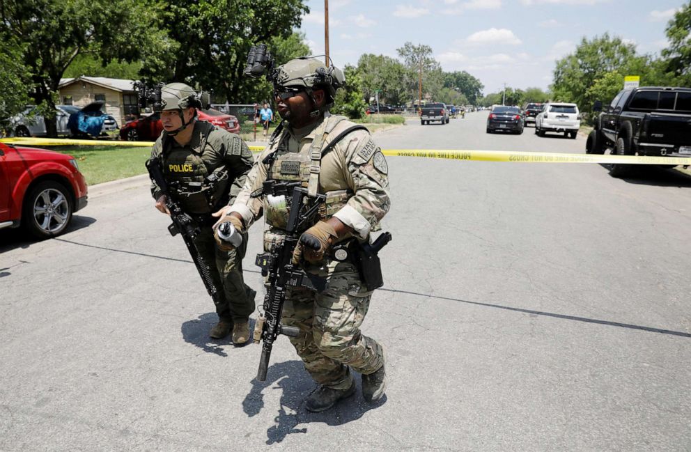 PHOTO: Law enforcement personnel move away from the scene of a suspected shooting near Robb Elementary School in Uvalde, Texas, May 24, 2022. 