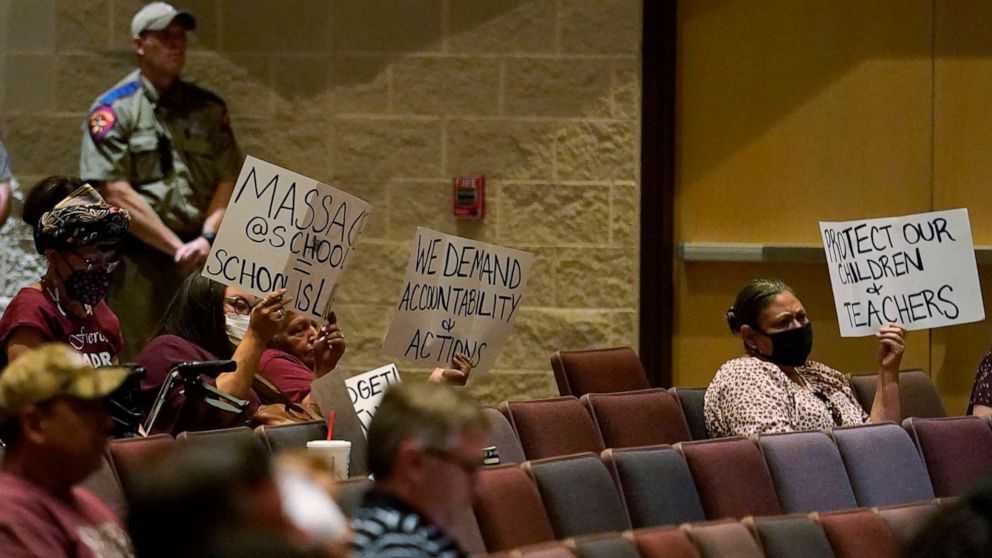 PHOTO: Parents and family hold protest signs during a special meeting of the Board of Trustees of Uvalde Consolidated Independent School District where parents addressed last month's shooting at Robb Elementary School, on July 18, 2022, in Uvalde, Texas.