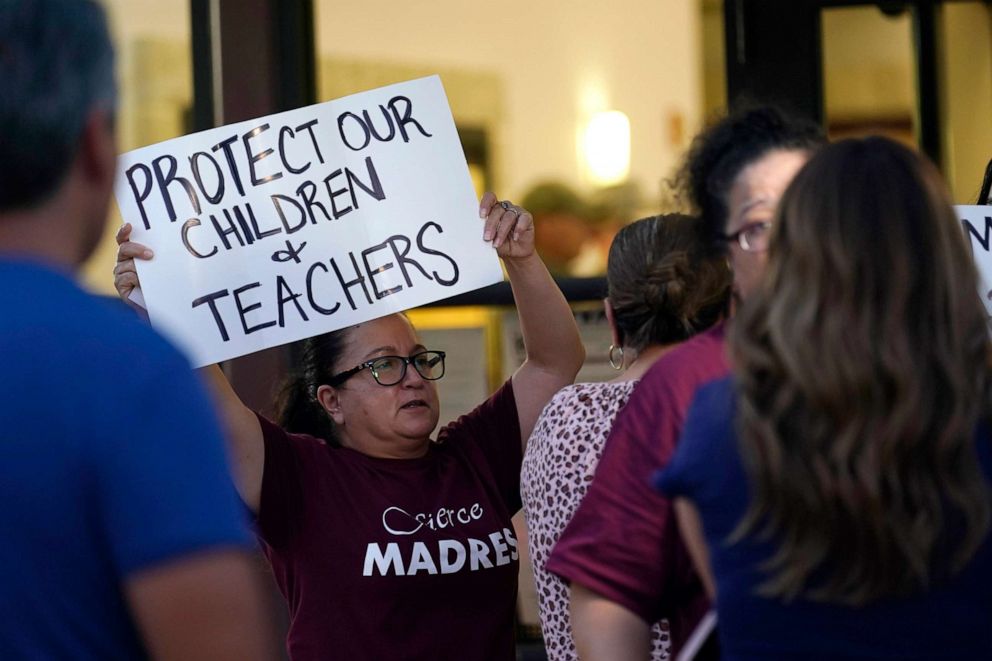 PHOTO: Parents and family of students hold protest signs during a special meeting of the Board of Trustees of Uvalde Consolidated Independent School District where parents addressed the shootings at Robb Elementary School, July 18, 2022, in Uvalde, Texas.