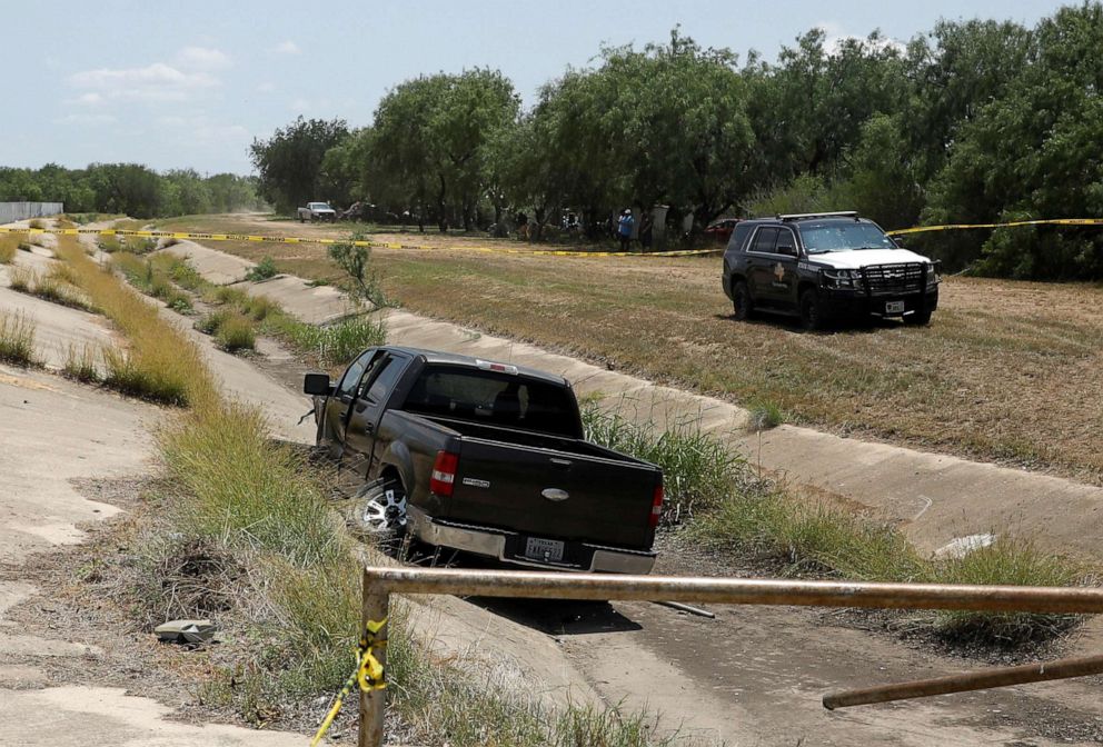 PHOTO: A police vehicle is seen parked near of a truck believed to belong to the suspected shooter in Ulvade, Texas, near Robb Elementary School, May 24, 2022. 