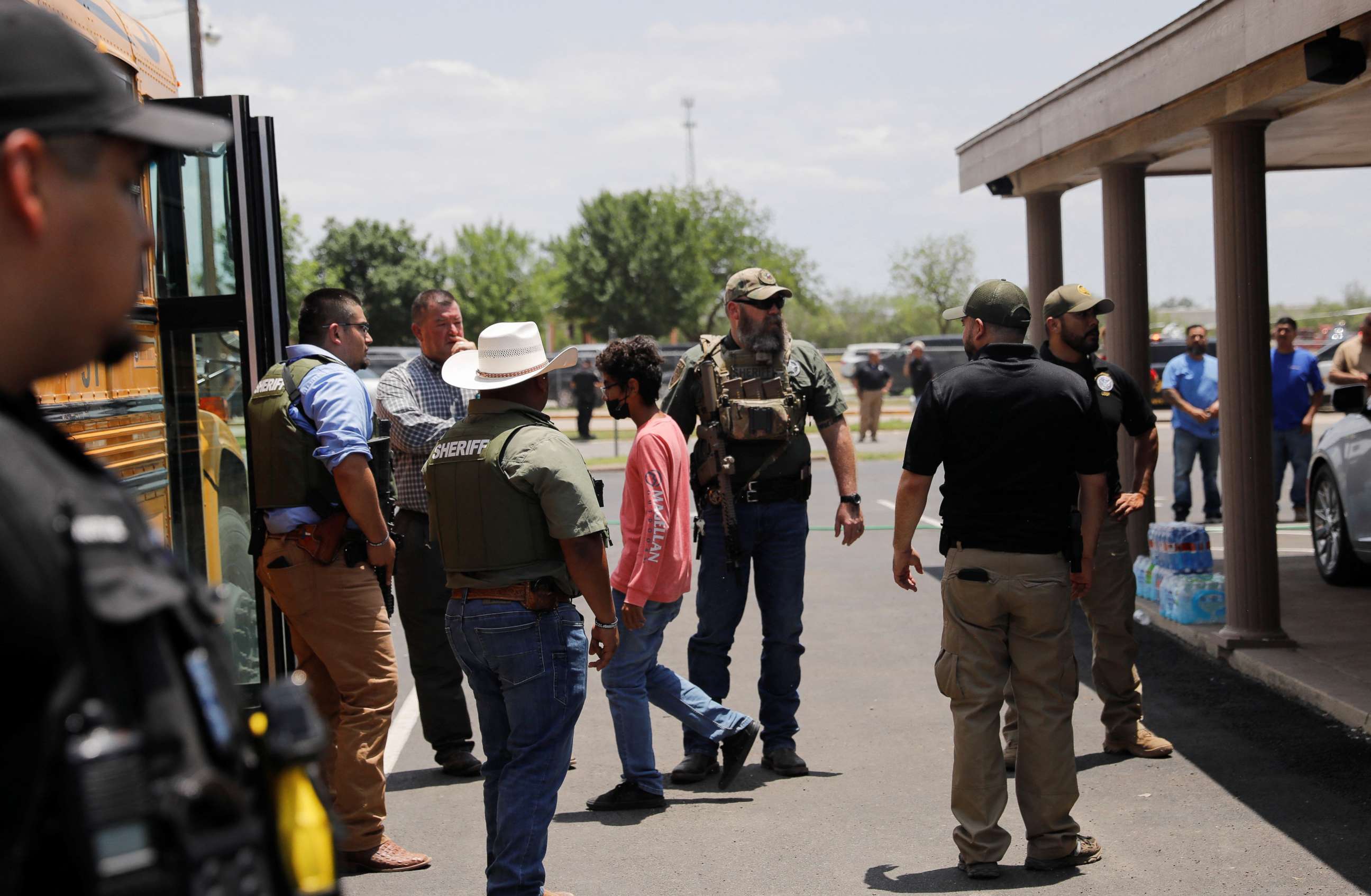 PHOTO: Children get on a school bus as law enforcement personnel guard the scene of a suspected shooting near Robb Elementary School in Uvalde, Texas, May 24, 2022.