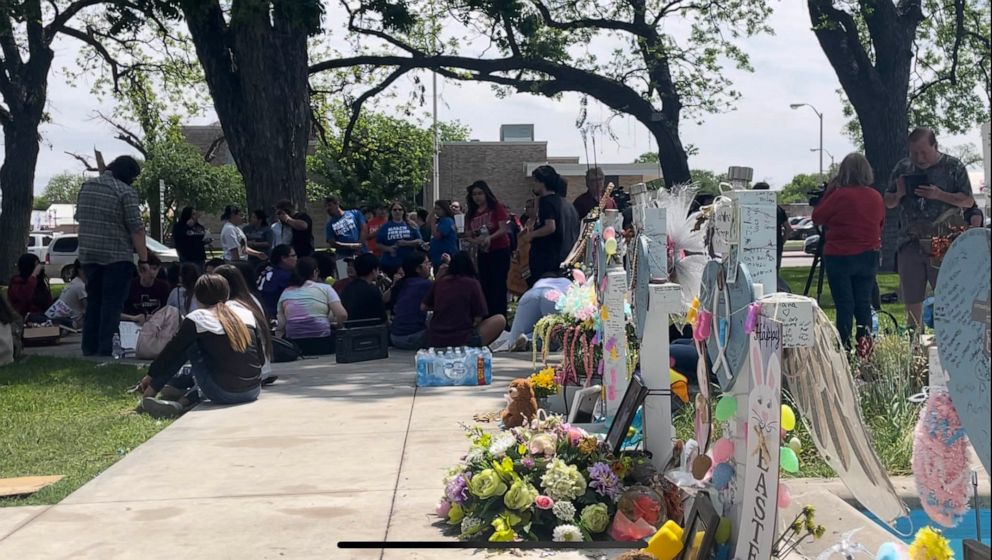 PHOTO: Students walk out of class to protest gun violence, near where Easter decorations have been placed at the victims' memorial site, in Uvalde Texas, on April 5, 2023.