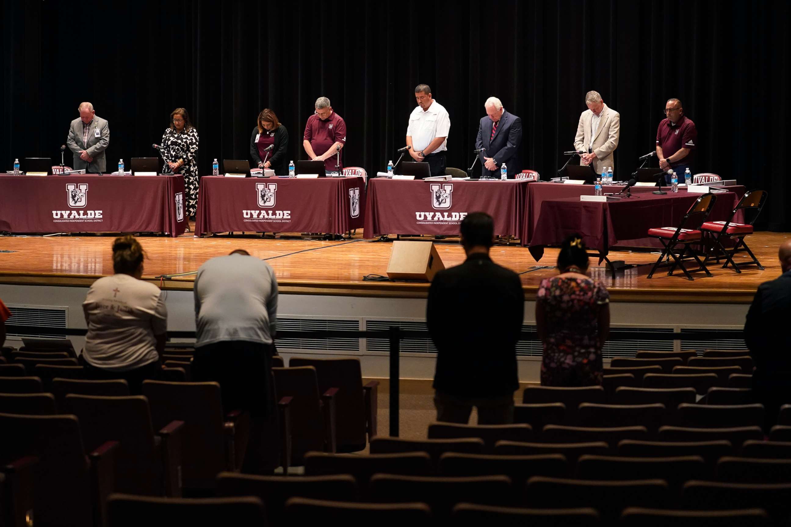 PHOTO: Dr. Hal Harrell, center, and members of the Board of Trustees of Uvalde Consolidated Independent School District stand for a moment of silence before a termination hearing in Uvalde, Texas, Aug. 24, 2022. 