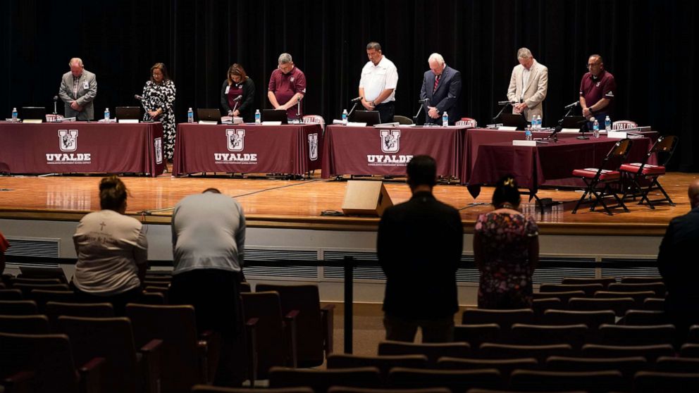 PHOTO: Dr. Hal Harrell, center, and members of the Board of Trustees of Uvalde Consolidated Independent School District stand for a moment of silence before a termination hearing in Uvalde, Texas, Aug. 24, 2022. 