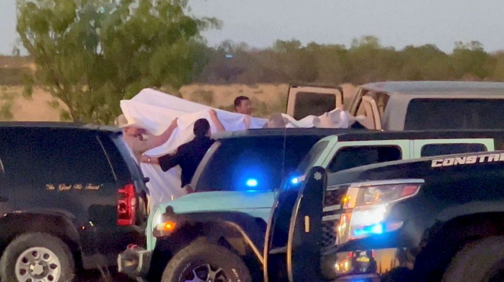 PHOTO: Law enforcement personnel are shown on the scene after two migrants suffocated to death aboard a freight train that got derailed, in Uvalde, Texas, on March 24, 2023, in this screengrab obtained from a social media video.