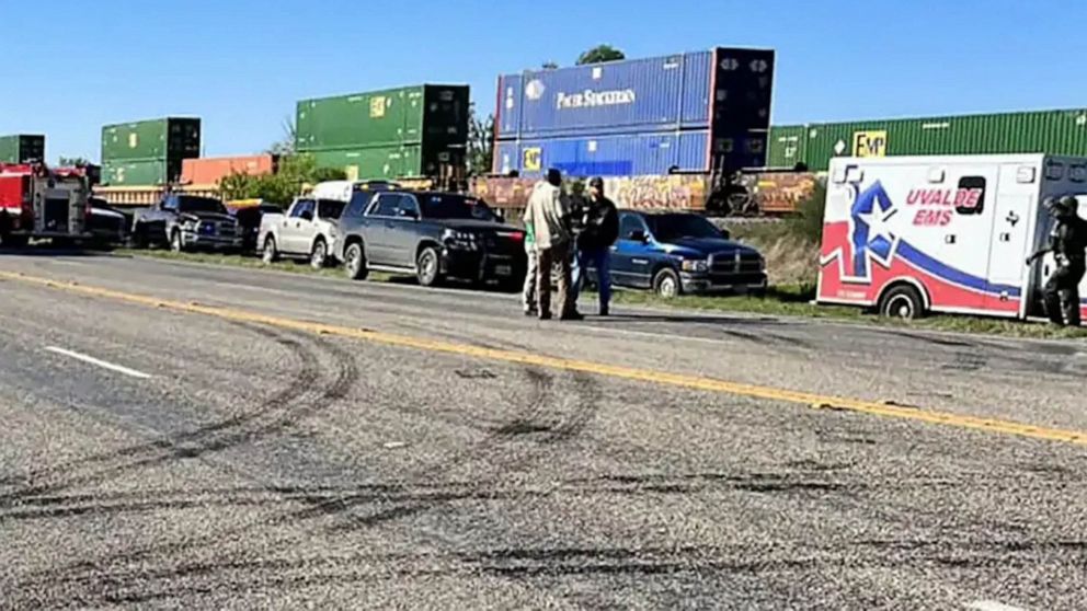 PHOTO: In this March 24, 2023, law enforcement and medical personnel gathered next to a stopped train near Knippa, Texas.