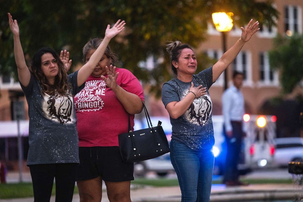 PHOTO: People become emotional at the City of Uvalde Town Square during a prayer vigil in the wake of a mass shooting at Robb Elementary School on May 24, 2022, in Uvalde, Texas.