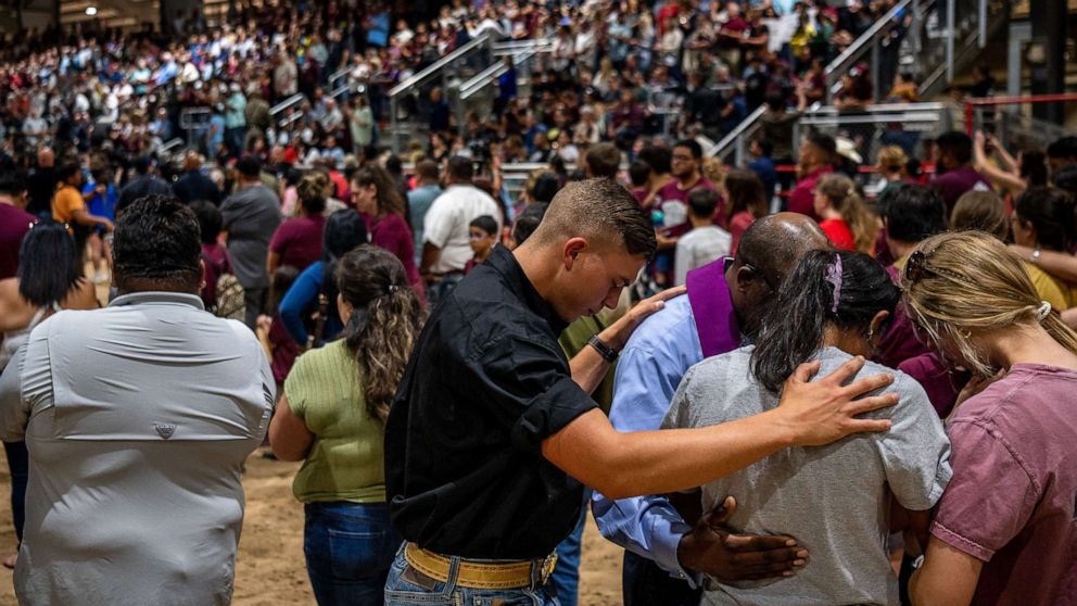 PHOTO: Community members pray together at a vigil, May 25, 2022, for the victims in the mass shooting at Rob Elementary School, in Uvalde, Texas.