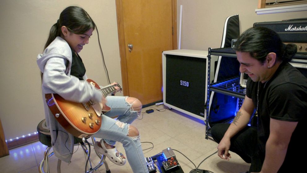 PHOTO: Caitlyne Gonzales rocks on an electric guitar with her instructor on Jan. 10, 2023.