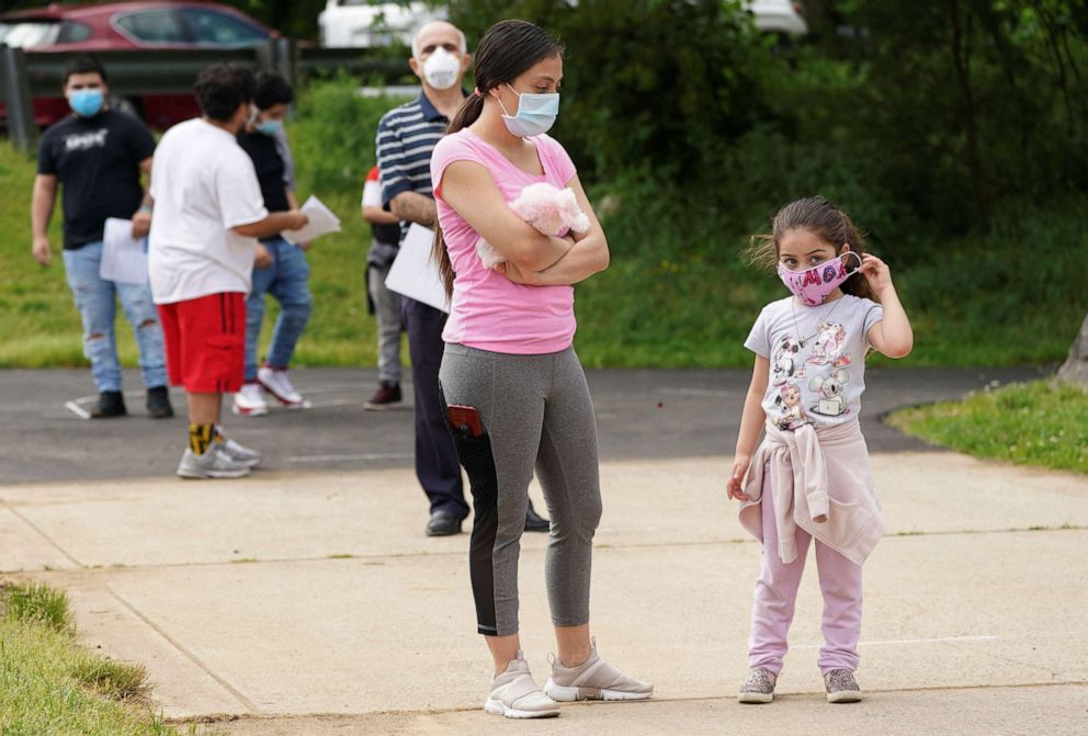 PHOTO: People wait in line to be tested for the coronavirus disease (COVID-19) in Arlington, Va., May 26, 2020.