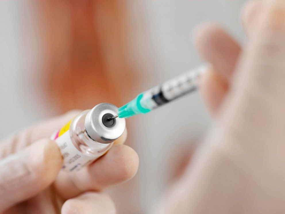 PHOTO: Syringe being filled. Drug or vaccine being drawn into a hypodermic syringe.Vaccination 