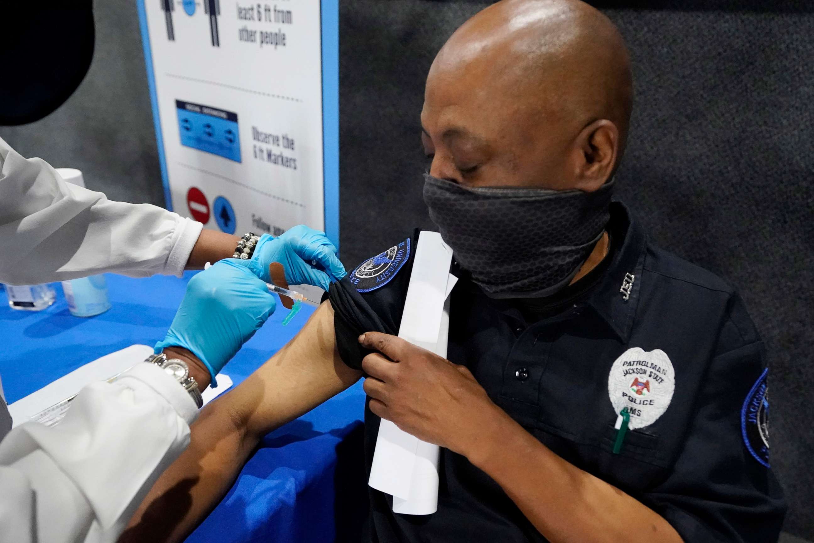 PHOTO: A Jackson State University police officer watches as a nurse gives him a dose of the Pfizer COVID-19 vaccine at an open vaccination site at Jackson State University in Jackson, Miss., Aug. 3, 2021.