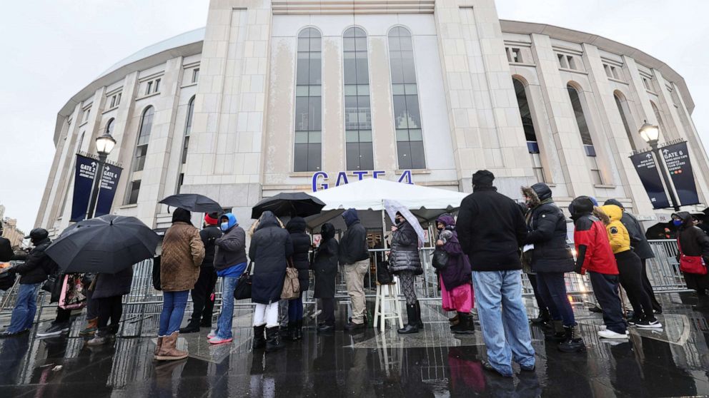 PHOTO: People wait in line to enter a coronavirus (COVID-19) vaccination site at Yankee Stadium on Feb. 5, 2021 in the Bronx, New York.