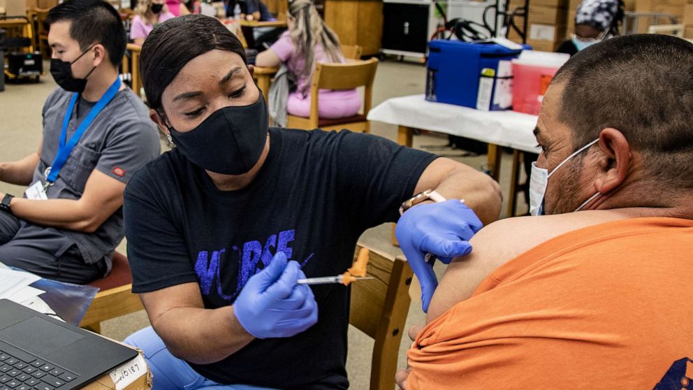 PHOTO: Nurse Francemene Henry administers the Pfizer vaccine at Arlington High School, Sept. 22, 2021 in Riverside, Calif.