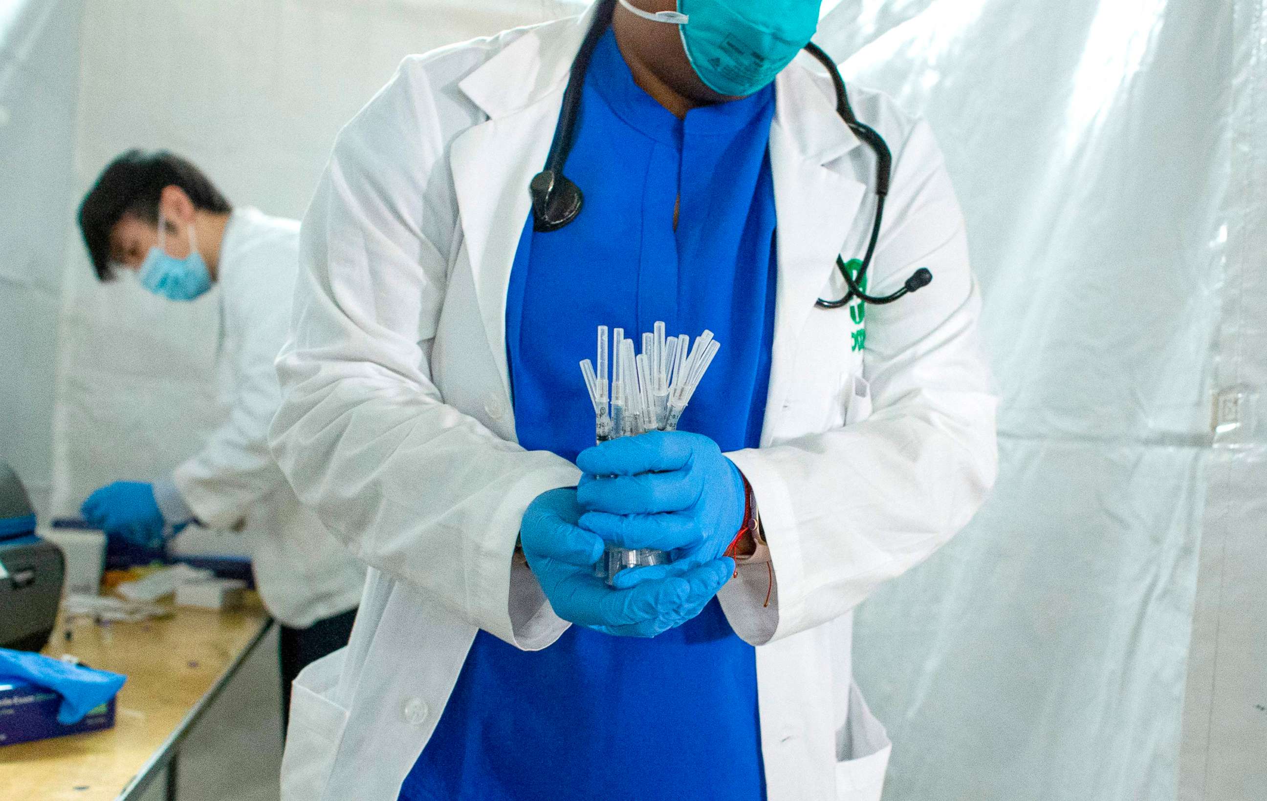 PHOTO: A health worker carries syringes to administer Pfizer COVID-19 vaccines at the opening of a new vaccination site at Corsi Houses in Harlem, New York, Jan. 15, 2021. 