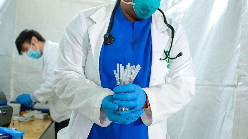 PHOTO: A health worker carries syringes to administer Pfizer COVID-19 vaccines at the opening of a new vaccination site at Corsi Houses in Harlem, New York, Jan. 15, 2021. 