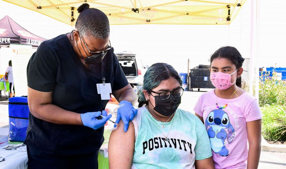 PHOTO: Brenda Vargas, 14, receives her Pfizer Covid-19 vaccine from vocational nurse Eon Walker at a mobile vaccine clinic hosted by Mothers in Action and operated by the Los Angeles County of Public Health, July 16, 2021, in Los Angeles.