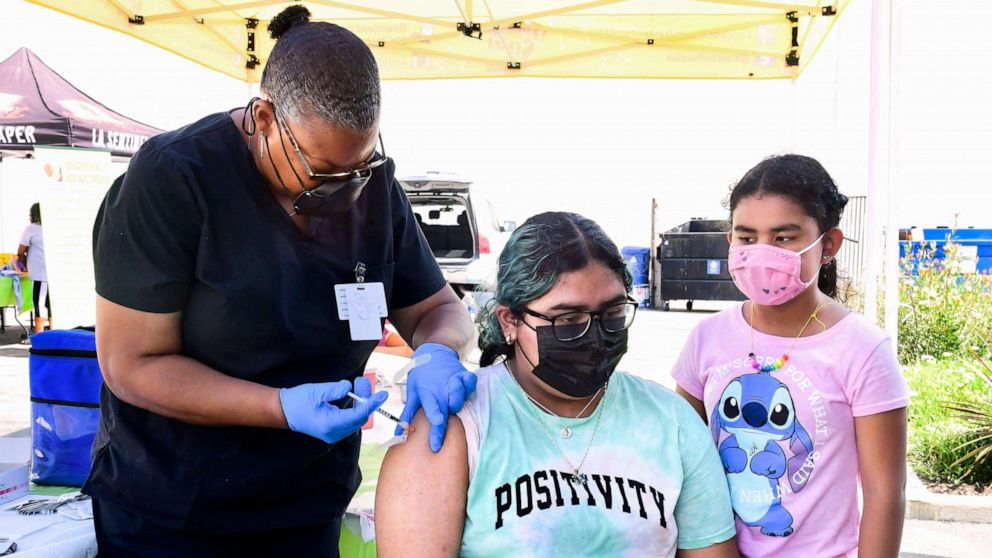 PHOTO: Brenda Vargas, 14, receives her Pfizer Covid-19 vaccine from vocational nurse Eon Walker at a mobile vaccine clinic hosted by Mothers in Action and operated by the Los Angeles County of Public Health, July 16, 2021, in Los Angeles.