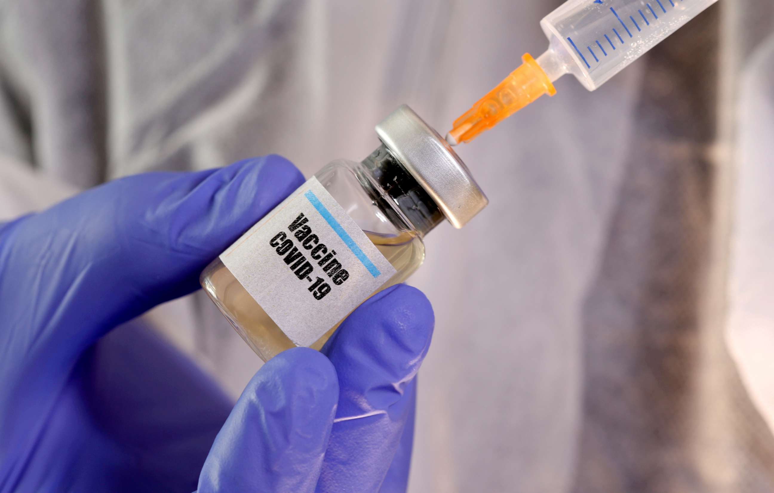 PHOTO: A medical syringe is inserted into a small bottle labeled "Vaccine COVID-19" in this illustration taken April 10, 2020.