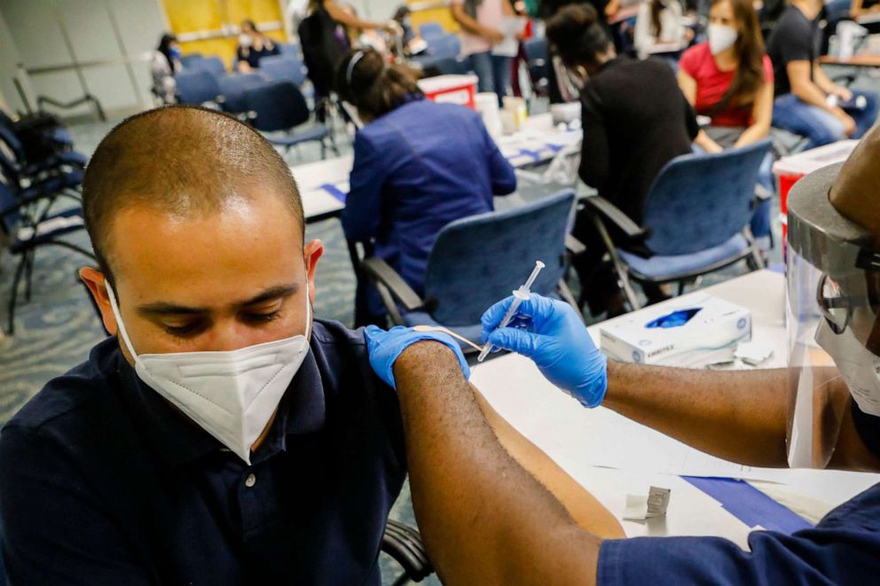 PHOTO: JosÃ© Pablo Mora receives a dose of Johnson & Johnson vaccine against Covid-19 at Miami International Airport, in Miami, Florida, on May 29, 2021.