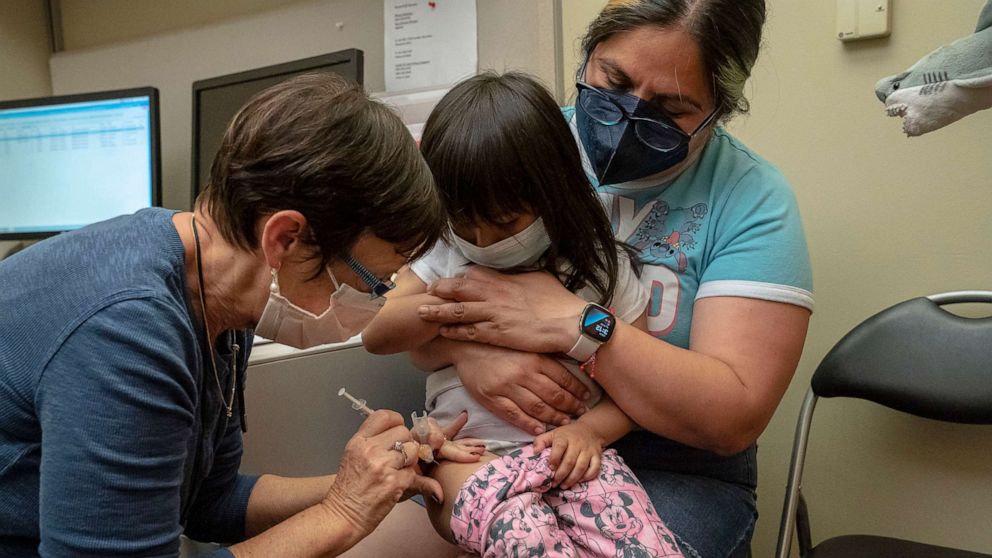 PHOTO: Deni Valenzuela, 2, receives her first dose of the Pfizer Covid-19 vaccination from nurse Deborah Sampson while being held by her mother Xihuitl Mendoza at UW Medical Center - Roosevelt, June 21, 2022, in Seattle.