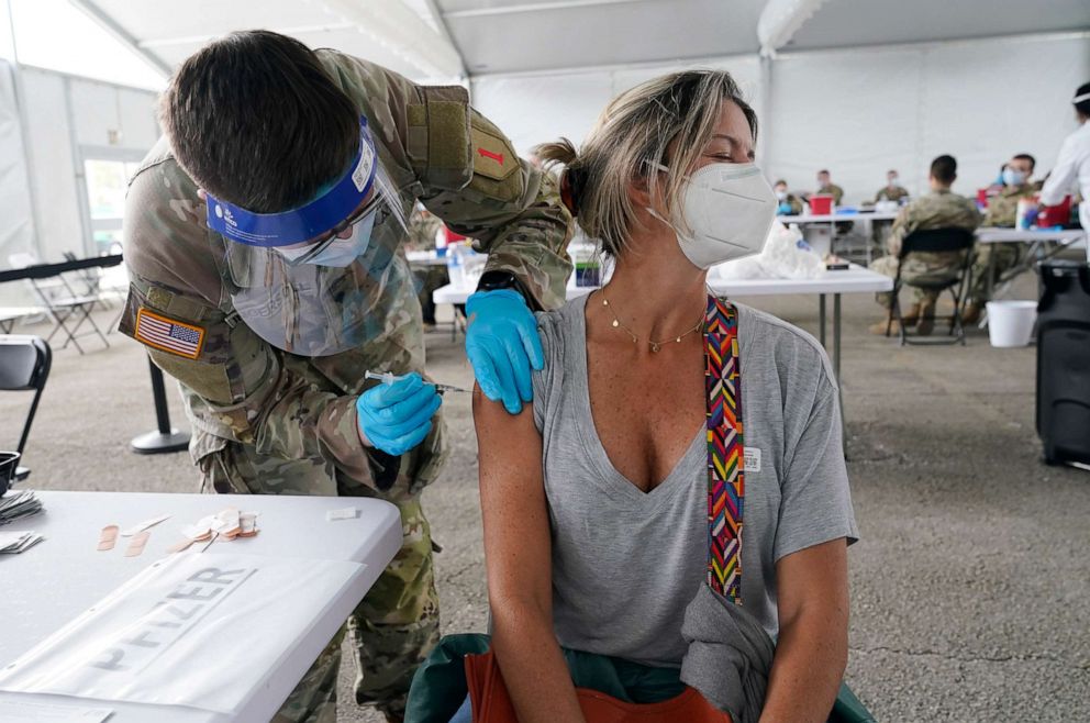 PHOTO: Liana Fonseca looks away as she receives the Pfizer COVID-19 vaccine, March 9, 2021, in Miami.