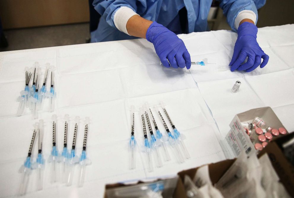 PHOTO: A pharmacy technician prepares a dose of the COVID-19 Pfizer vaccine to be administered to a patient at Harbor-UCLA Medical Center amid a surge of coronavirus patients on Jan. 21, 2021, in Torrance, Calif.