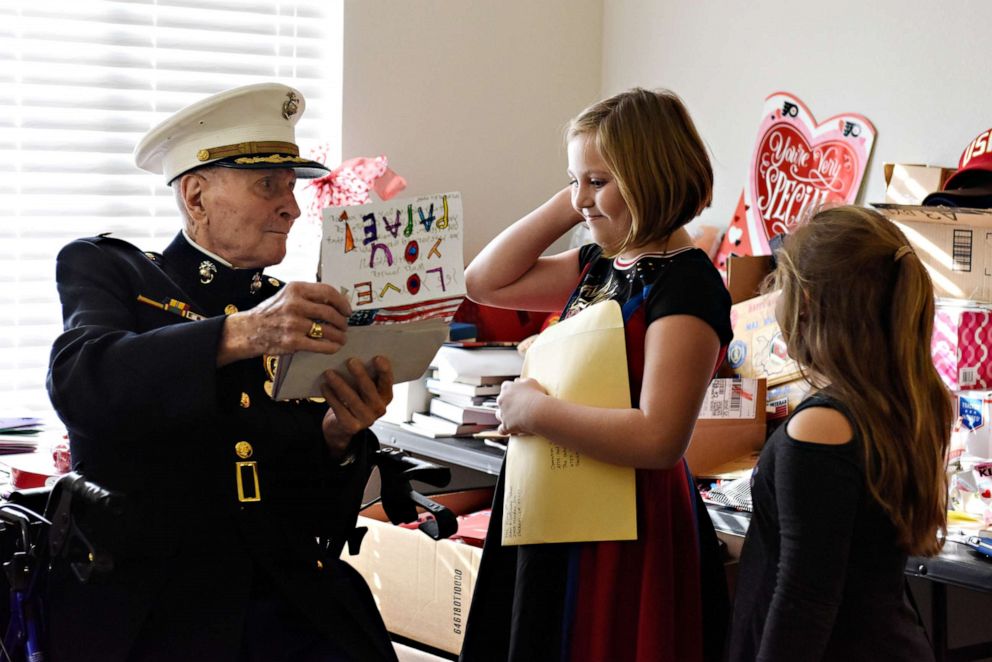 PHOTO: Major Bill White reads through Valentine's Day cards with his great granddaughters Abigail Sawyer, nine-years-old, and Nicole Sawyer, seven-years-old, at an assisted living facility in Stockton, Calif., Jan. 31, 2020.