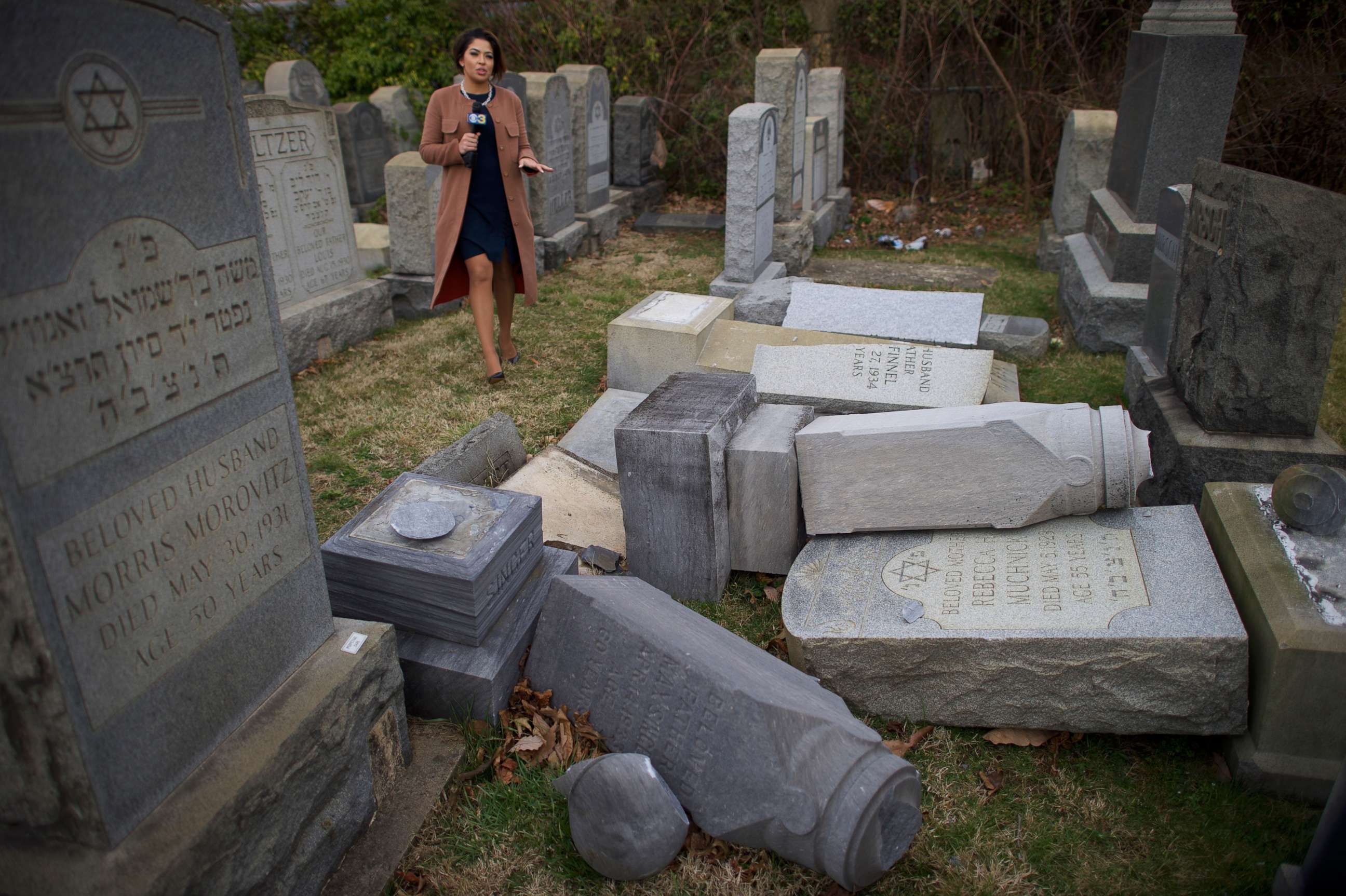 PHOTO: A television reporter broadcasts in front of vandalized Jewish tombstones at Mount Carmel Cemetery Feb. 27, 2017 in Philadelphia.