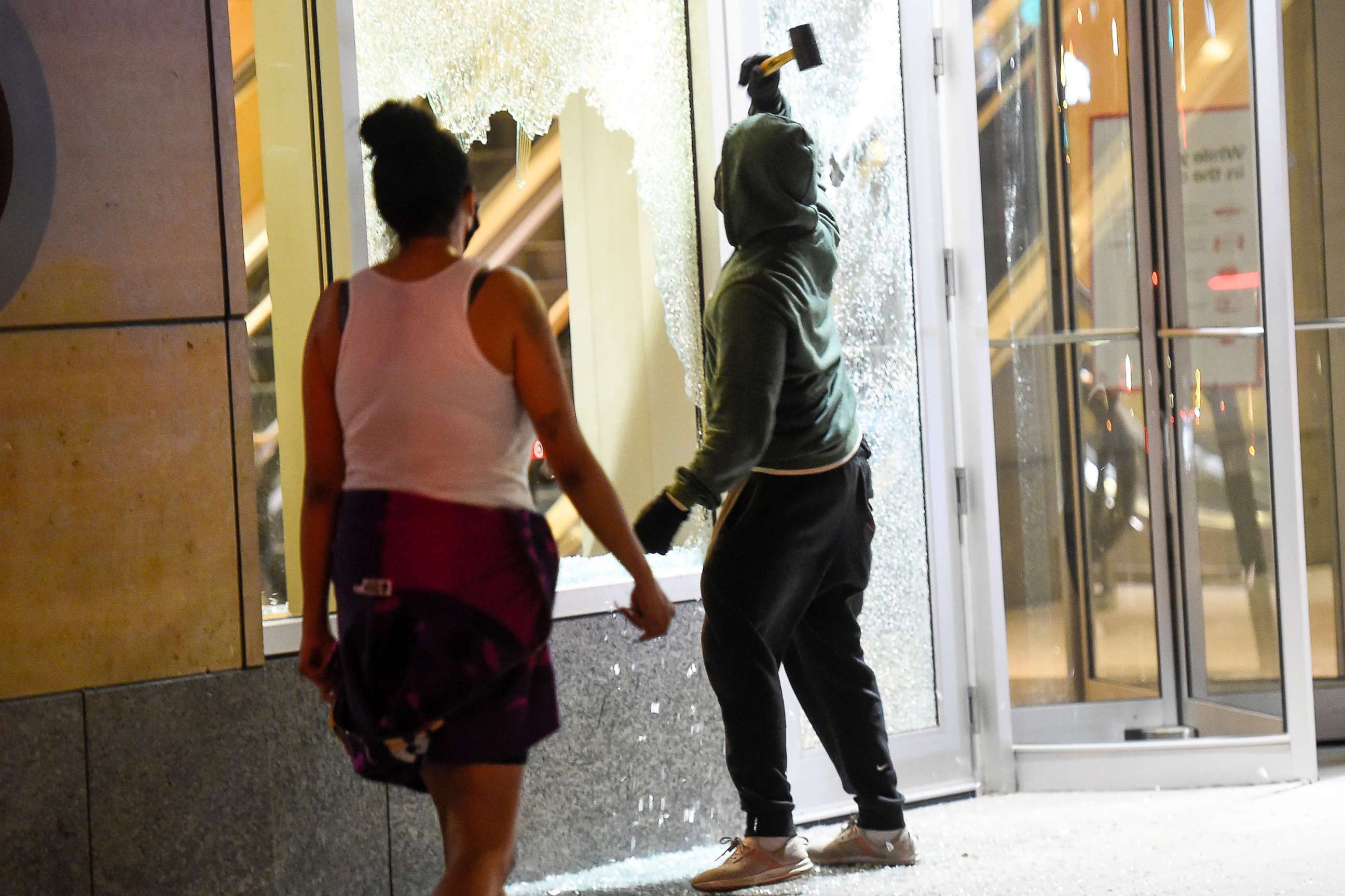 PHOTO: Windows are smashed at Target headquarters as people clash with police after a homicide suspect killed himself as police closed in on him in downtown Minneapolis, Aug. 2020.
