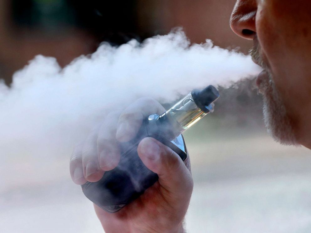 PHOTO: In this Aug. 28, 2019, photo a man exhales while smoking an e-cigarette in Portland, Maine.