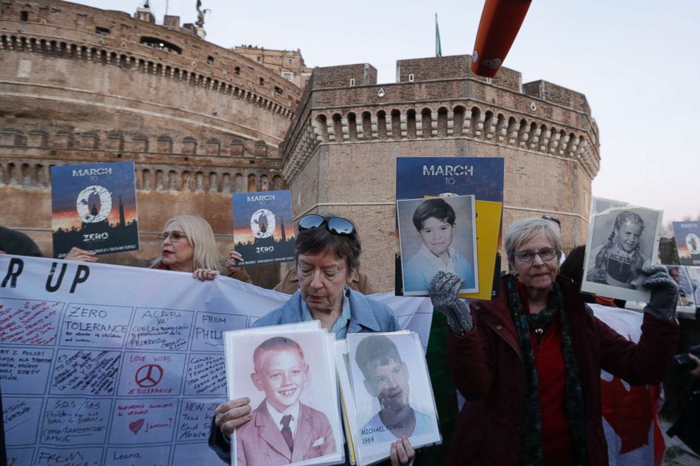 PHOTO: People hold up pictures of what they claim to be victims of priests sexual abuse as they gather during a twilight vigil prayer near Castle Sant' Angelo, in Rome, Feb. 21, 2019. 