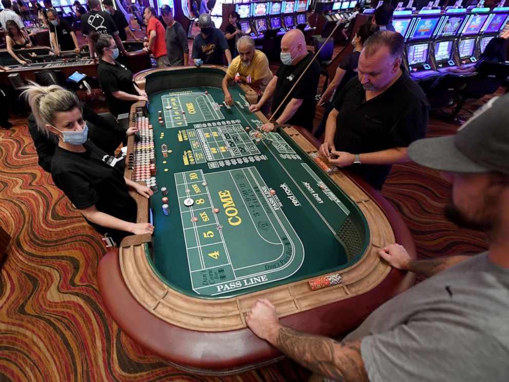 PHOTO: Guests play craps at the Red Rock Resort after the property opened for the first time since being closed on March 17 because of the coronavirus (COVID-19) pandemic on June 4, 2020 in Las Vegas.