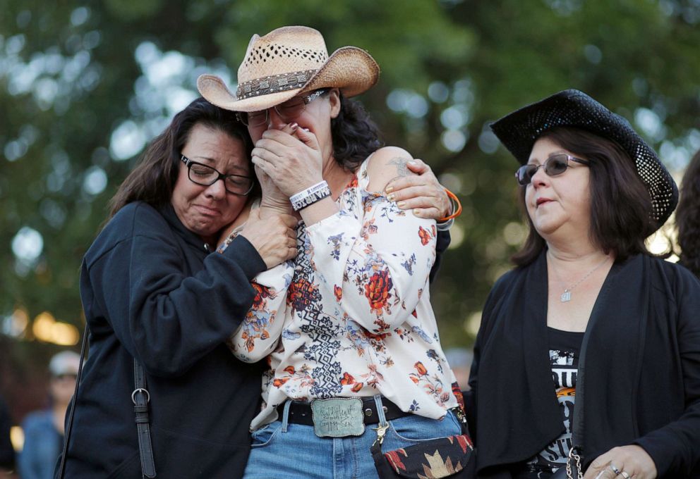 PHOTO: Yvonne Justice, left, comforts Emily Sebring during a ceremony, Oct. 1, 2019, on the anniversary of the mass shooting two years earlier, in Las Vegas.