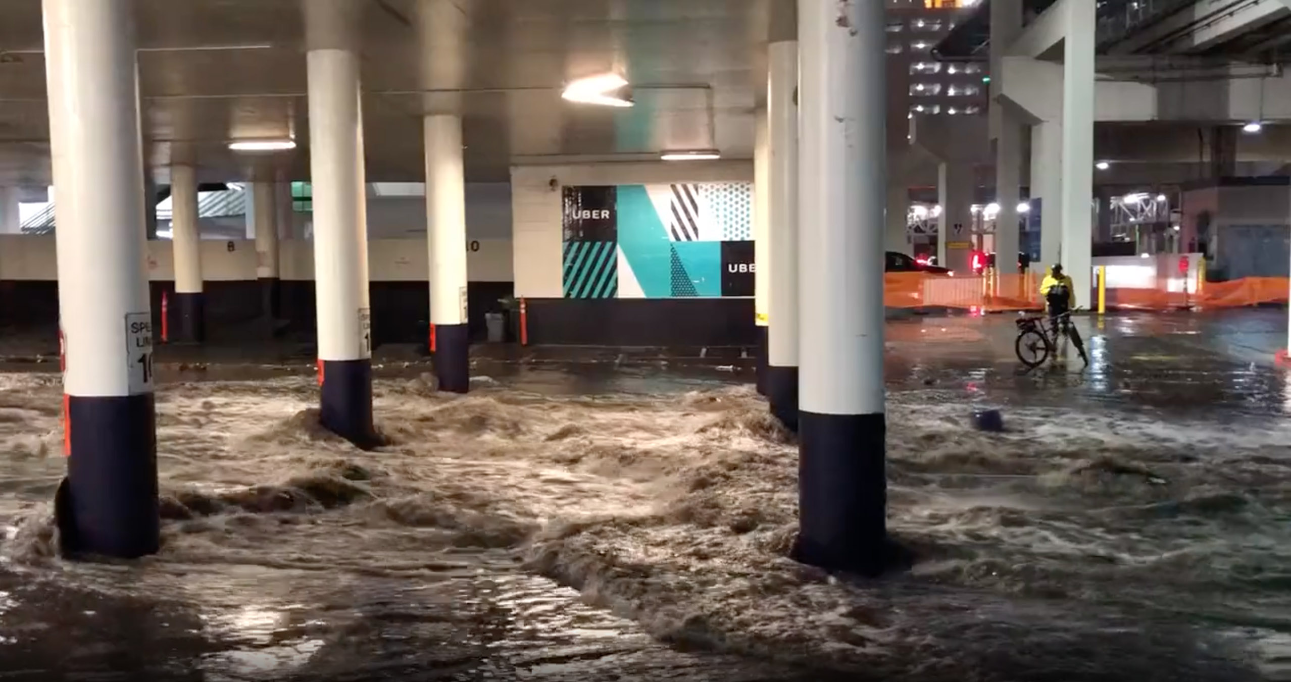 PHOTO: Water rushes through a parking garage during flash flooding on the Las Vegas strip, July 28, 2022.