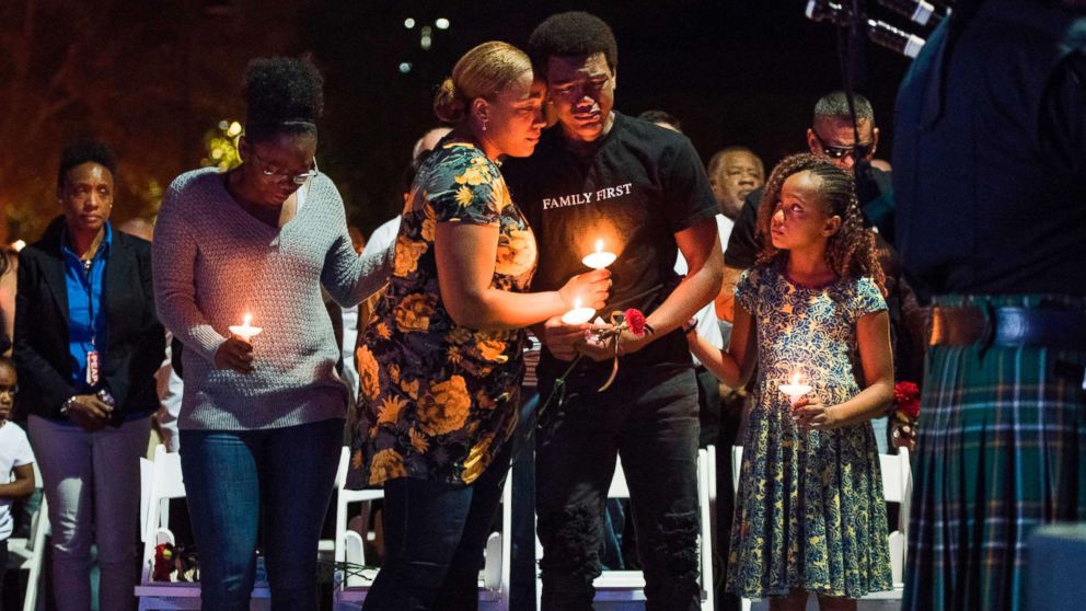 Veronica Hartfield, center left, widow of Las Vegas Metropolitan Police Department Officer Charleston Hartfield, their son Ayzayah Hartfield, daughter Savannah Hartfield, right, and Hartfield's sister Denita Hartfield,left, attend a vigil for Charleston Hartfield at Police Memorial Park on October 5, 2017 in Las Vegas, Nevada.