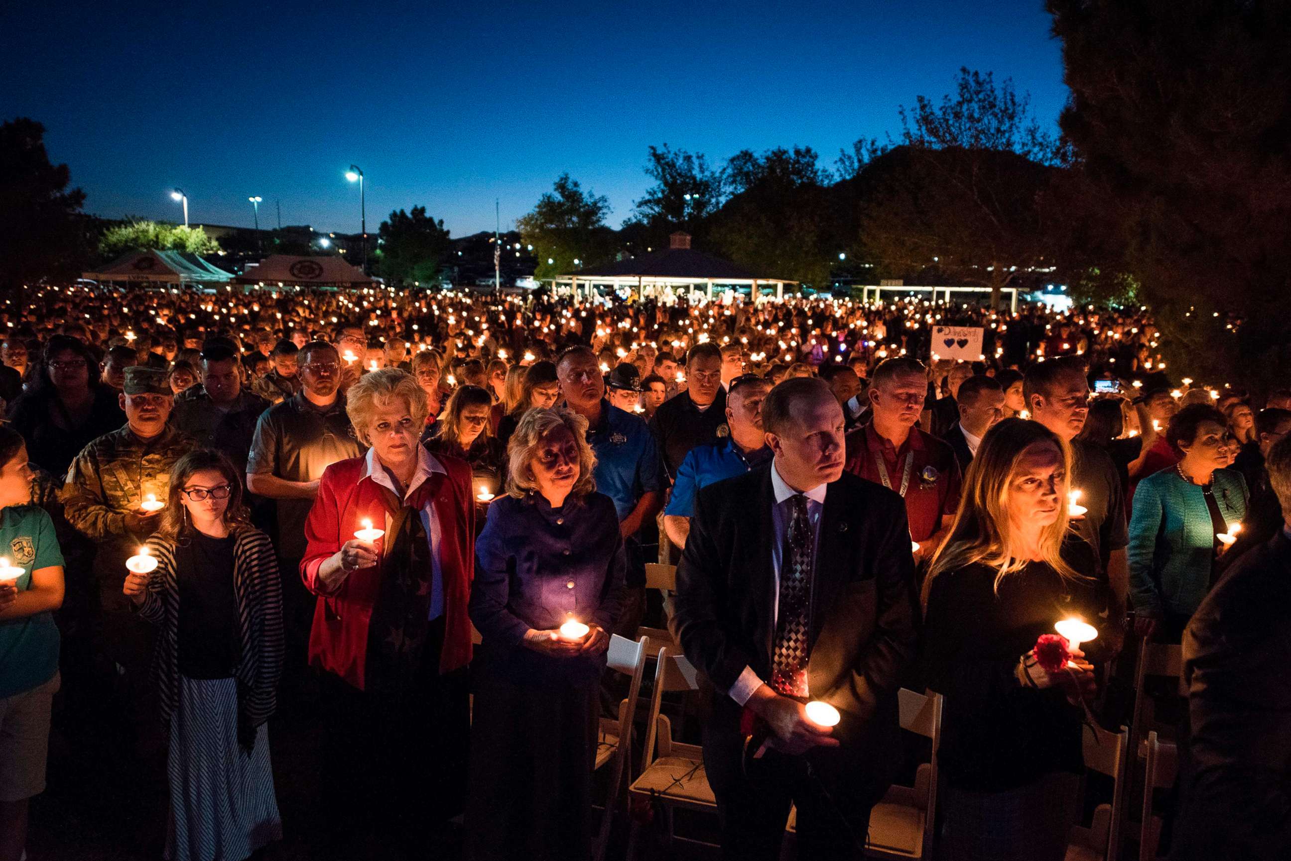 PHOTO: A large crowd of people hold candles at a memorial service for Charleston Hartfield, a Las Vegas police officer who was killed on Oct. 1, 2017 when a gunman opened fire on a county music festival, in Las Vegas, Nevada, Oct. 5, 2017.