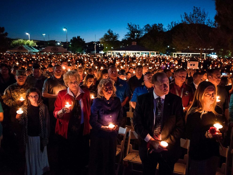 PHOTO: A large crowd of people hold candles at a memorial service for Charleston Hartfield, a Las Vegas police officer who was killed on Oct. 1, 2017 when a gunman opened fire on a county music festival, in Las Vegas, Nevada, Oct. 5, 2017.