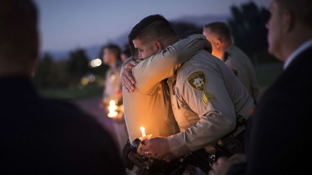 Sgt. Ryan Fryman, who was on the scene of the mass shooting, hugs a fellow officer during a vigil, Oct. 5, 2017 in Las Vegas for Police Officer Charleston Hartfield, who was killed when a gunman opened fire on a crowd attending a music festival.