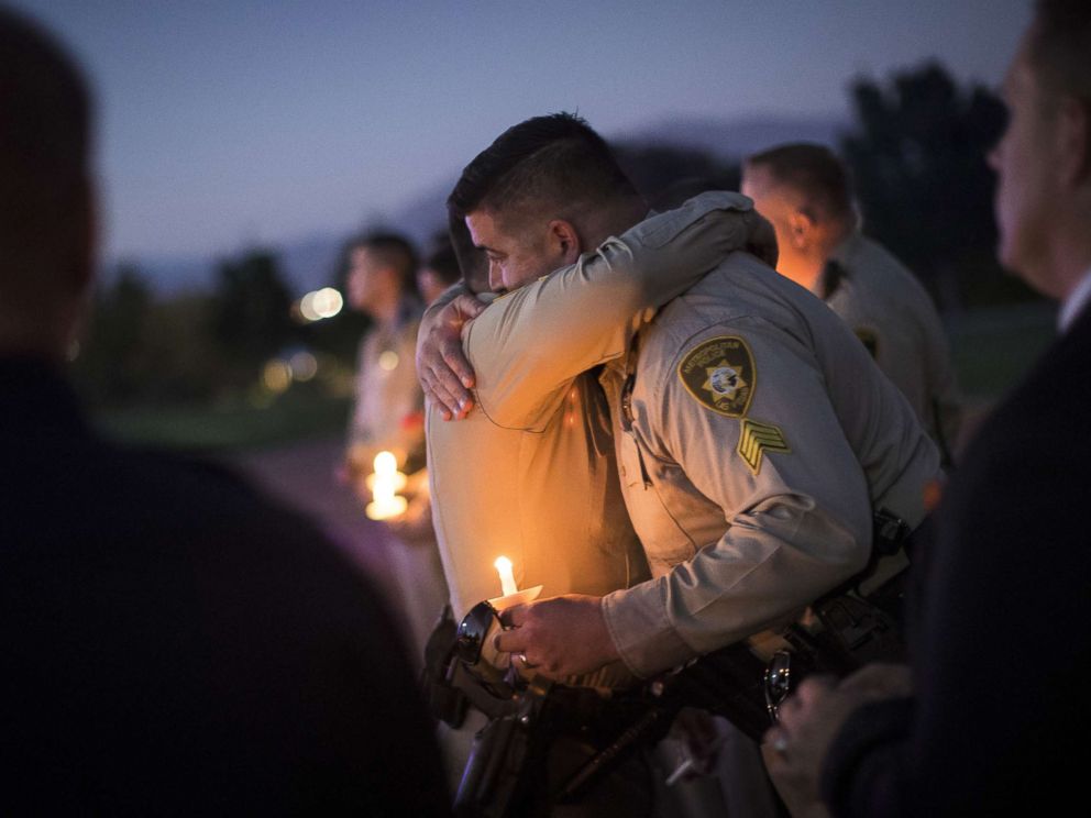 PHOTO: Sgt. Ryan Fryman, who was on the scene of the mass shooting, hugs a fellow officer during a vigil, Oct. 5, 2017 in Las Vegas for Police Officer Charleston Hartfield, who was killed when a gunman opened fire on a crowd attending a music festival.