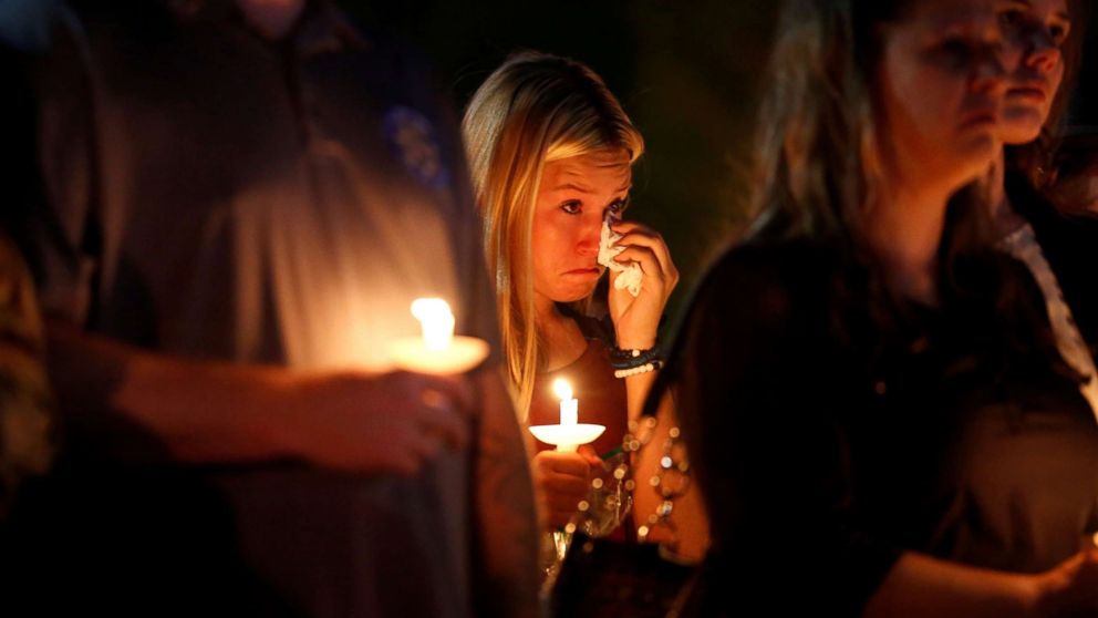 A woman wipes away tears during a memorial service for Charleston Hartfield, an off-duty Las Vegas police officer who was killed during the Route 91 music festival mass shooting, in Las Vegas, Nevada, Oct. 5, 2017.
