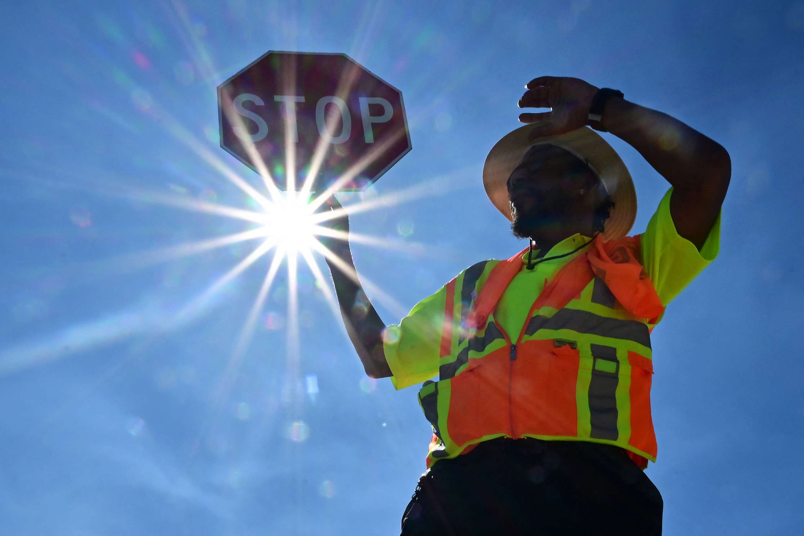 PHOTO: Traffic warden Rai Rogers mans his street corner under the hot sun in Las Vegas, Nevada on July 12, 2023, where temperatures reached 106 degrees amid an ongoing heatwave.