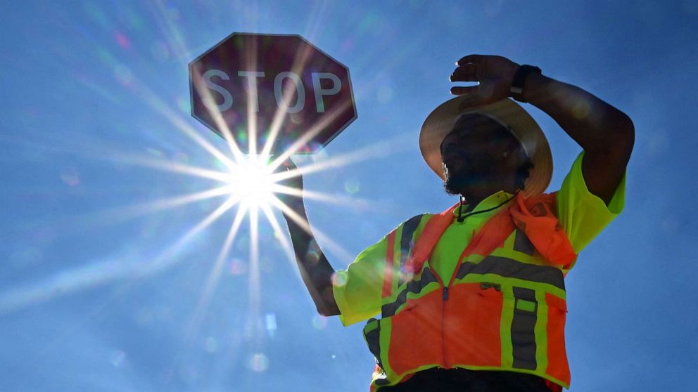 PHOTO: Traffic warden Rai Rogers mans his street corner under the hot sun in Las Vegas, Nevada on July 12, 2023, where temperatures reached 106 degrees amid an ongoing heatwave.