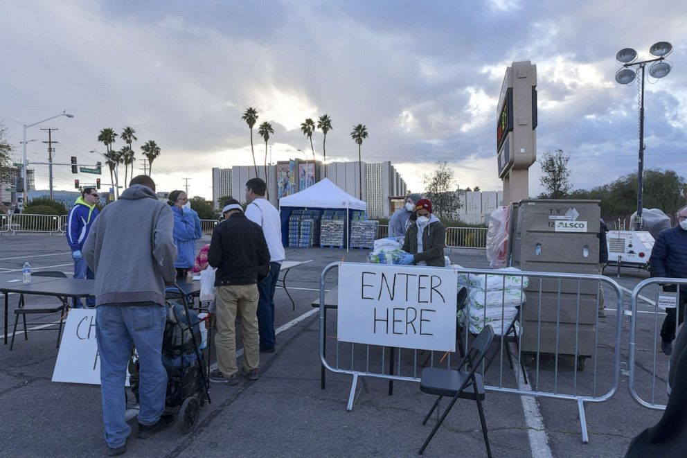 PHOTO: People enter a temporary homeless shelter now open at Cashman Center in Las Vegas, Nevada, March 29, 2020.