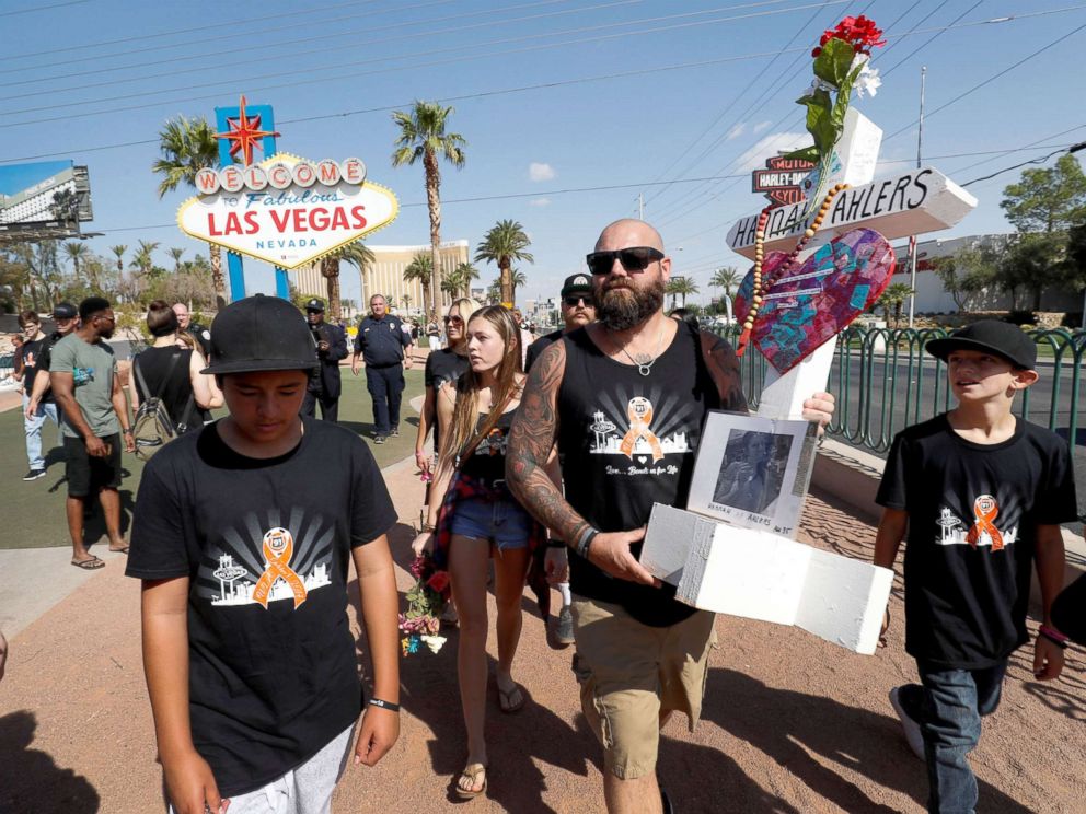 PHOTO: Route 91 shooting survivor Brian Ahlers carries a cross representing his wife Hannah, one of the 58 victims, during the one-year anniversary of the October 1, 2017 mass shooting in Las Vegas, Oct. 1, 2018.